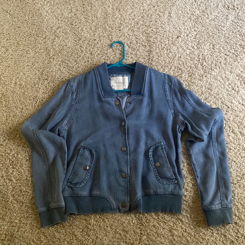 Anthropologie lightweight denim jacket with snaps in the front.